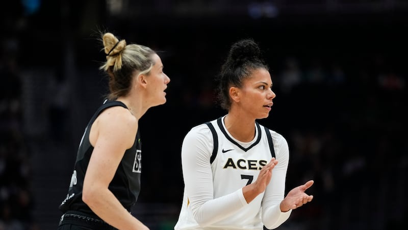 Las Vegas Aces forward Alysha Clark (7) claps as Seattle Storm guard Sami Whitcomb looks on...