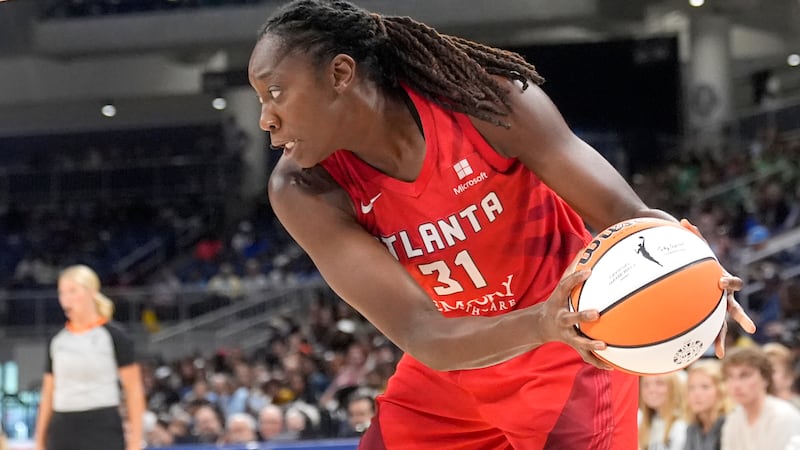 Atlanta Dream's Tina Charles maneuvers around the basket in a WNBA basketball game against the...