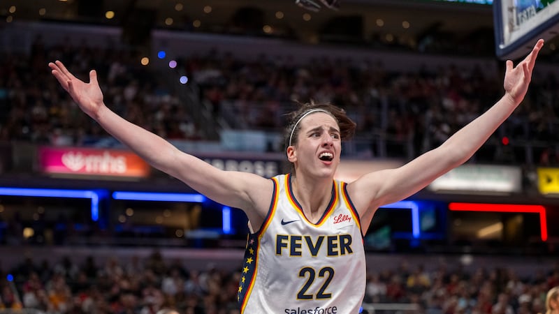 Indiana Fever guard Caitlin Clark reacts after scoring against the Seattle Storm during the...