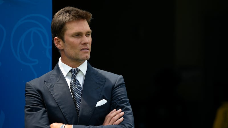 Tom Brady watches warmups before a preseason NFL football game between the Dallas Cowboys and...