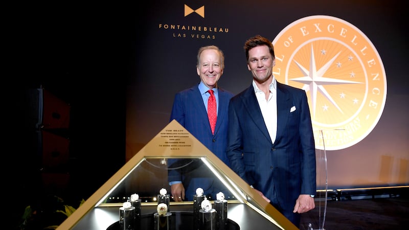 Gray and Brady stand by the display of the legendary quarterback's Super Bowl rings in the...