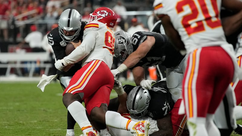 Las Vegas Raiders quarterback Gardner Minshew (15) is stopped by Kansas City Chiefs defensive...