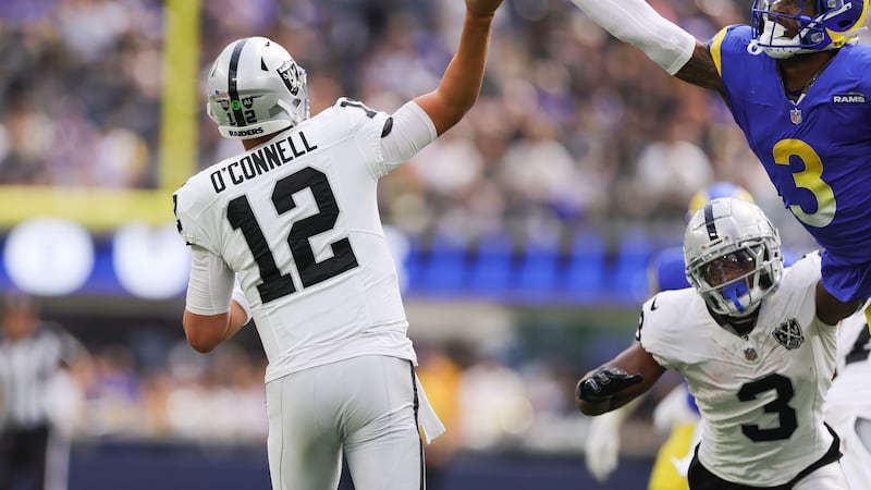 Las Vegas Raiders quarterback Aidan O'Connell (12) attempts to throw a pass as Los Angeles...