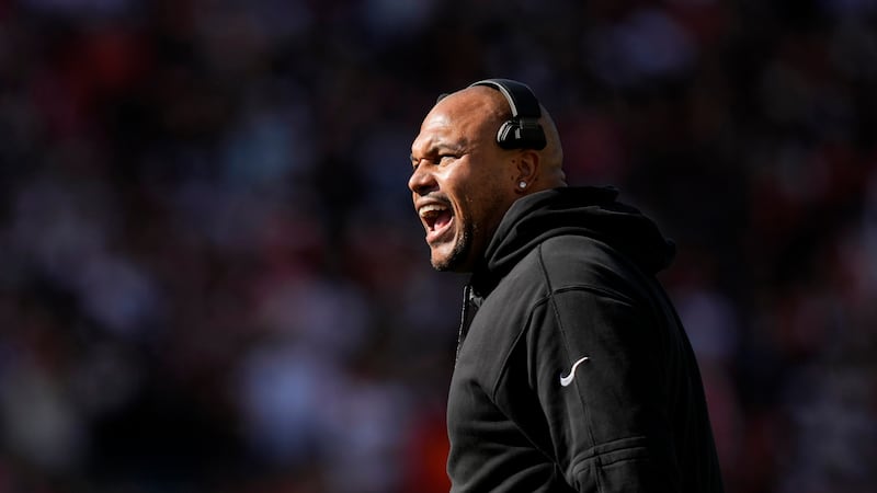 Las Vegas Raiders head coach Antonio Pierce reacts during the first half of an NFL football...