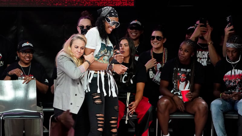 Las Vegas Aces head coach Becky Hammon, left, embraces A'ja Wilson during a rally to celebrate...