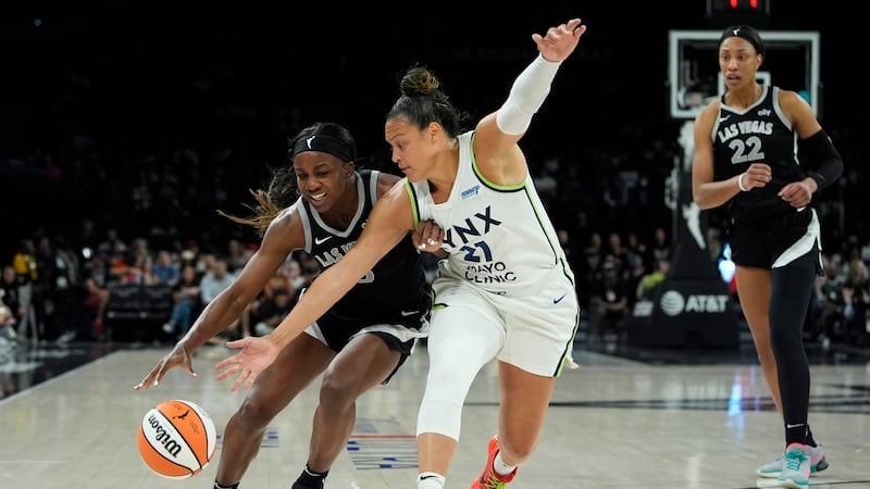 Minnesota Lynx guard Kayla McBride, right, guards Las Vegas Aces guard Jackie Young (0) during...