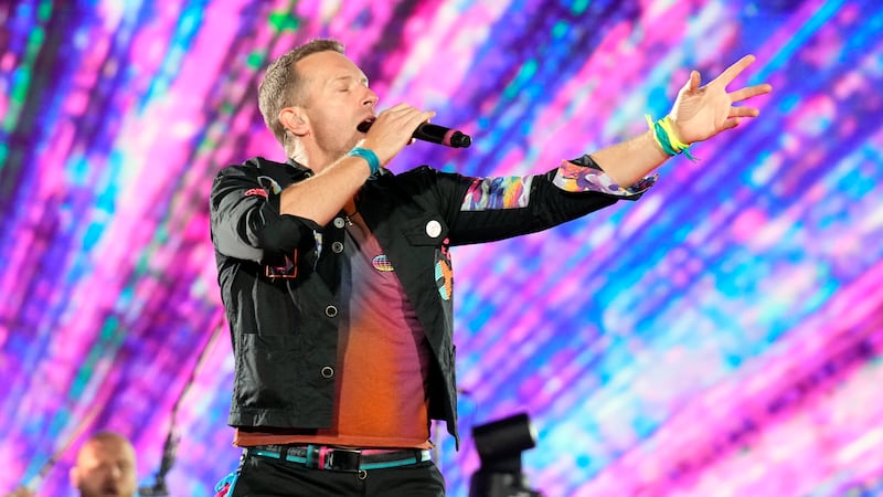 FILE - Chris Martin of Coldplay, performs during the band's Music of the Spheres world tour on...