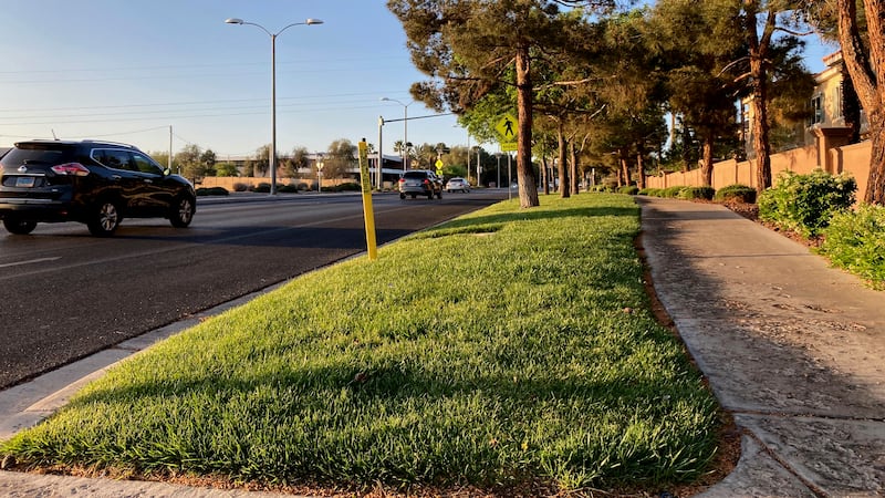 In this April 9, 2021, file photo, traffic passes a grassy landscape on Green Valley Parkway...