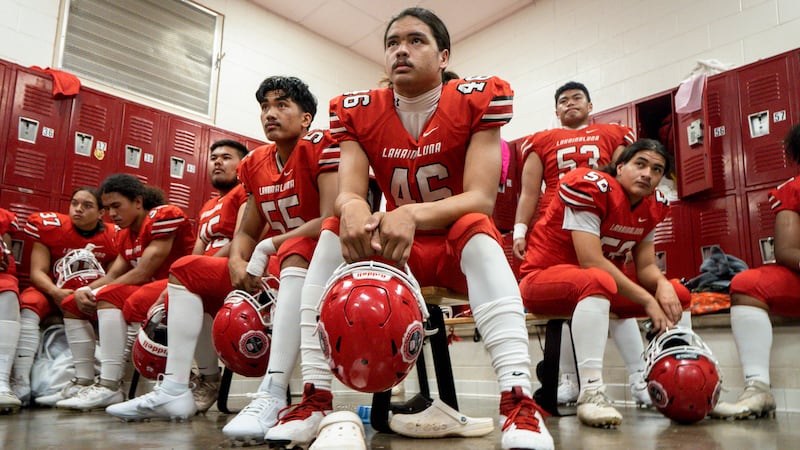 FILE - Lahainaluna High School football team players listens to co-head coach Dean Rickard...