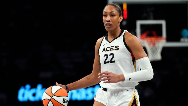 FILE - Las Vegas Aces' A'ja Wilson (22) looks to pass during the first half in Game 3 of a...