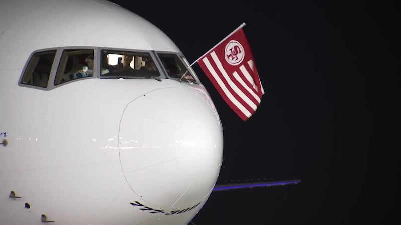 A 49'ers flag emerges from a cockpit window after the team landed in Las Vegas Sunday night...