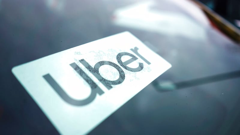 An Uber sign is displayed inside a car in Palatine, Ill., Thursday, Feb. 10, 2022.