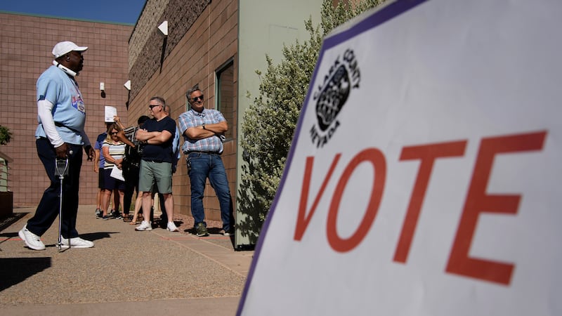 People wait in line to vote at a polling place on June 14, 2022, in Las Vegas. (AP Photo/John...