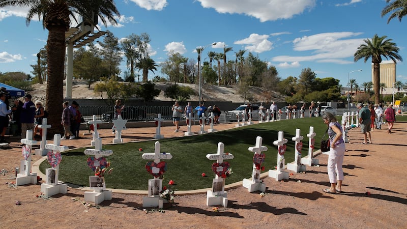 People visit a makeshift memorial for victims of the Oct. 1, 2017, mass shooting in Las Vegas,...