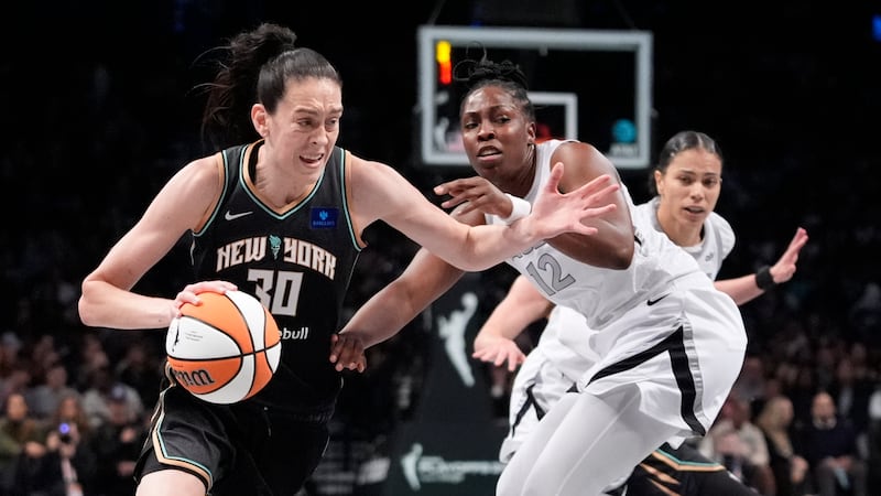 New York Liberty's Breanna Stewart (30) drives past Las Vegas Aces' Chelsea Gray (12) during...